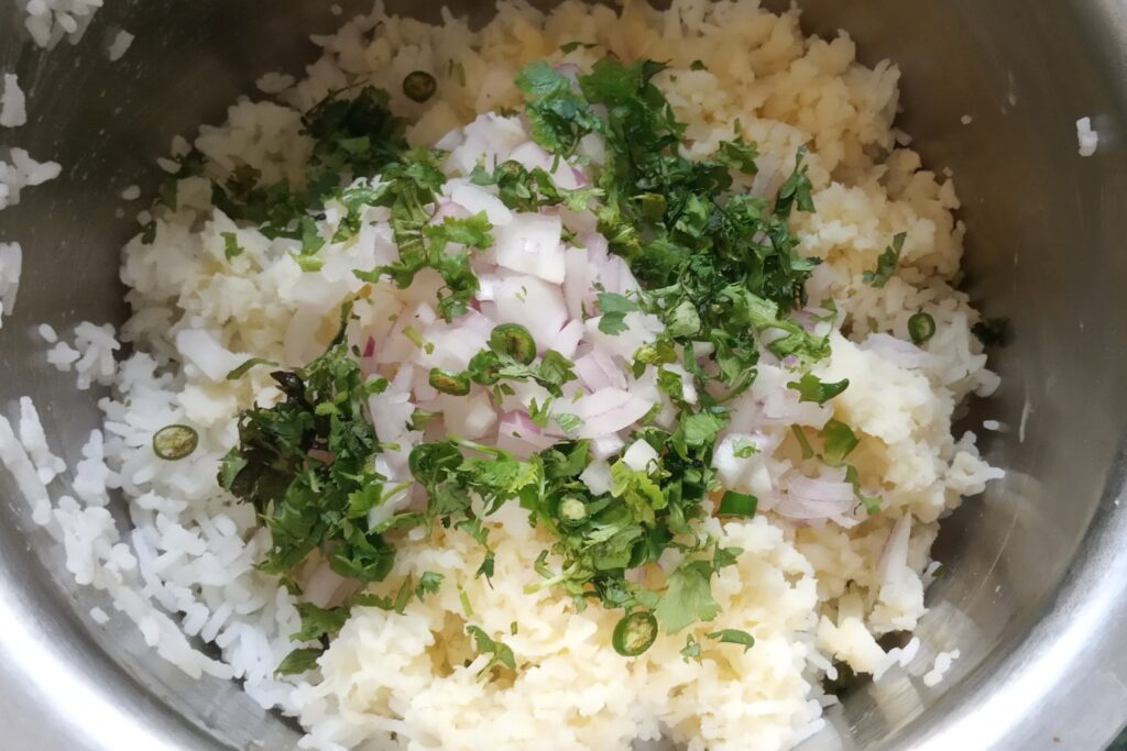 onion green chili and herbs are added