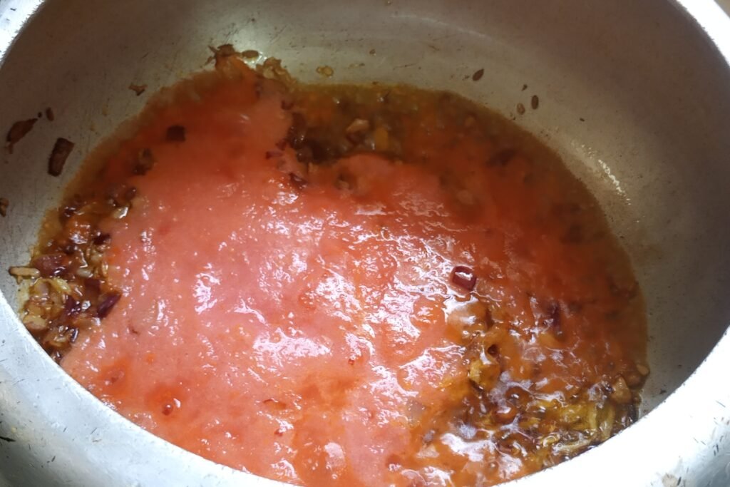 sauteing tomato puree with onion