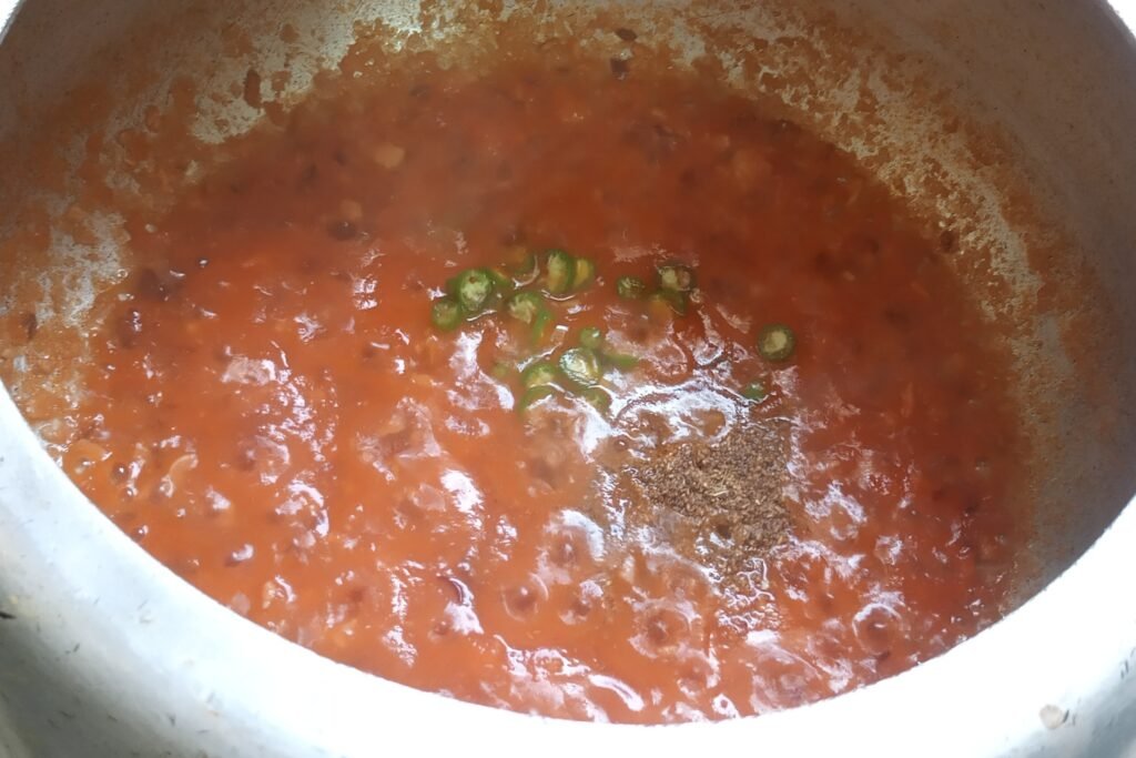 cooking tomato masala with green chili