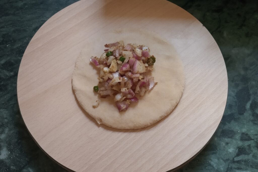onion mixture placed on rolled circle
