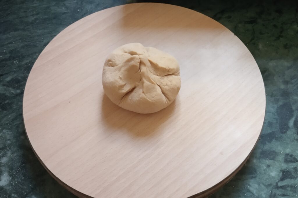 the sealed stuffed dough on rolling board