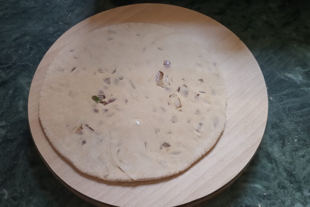 rolled paratha on rolling board