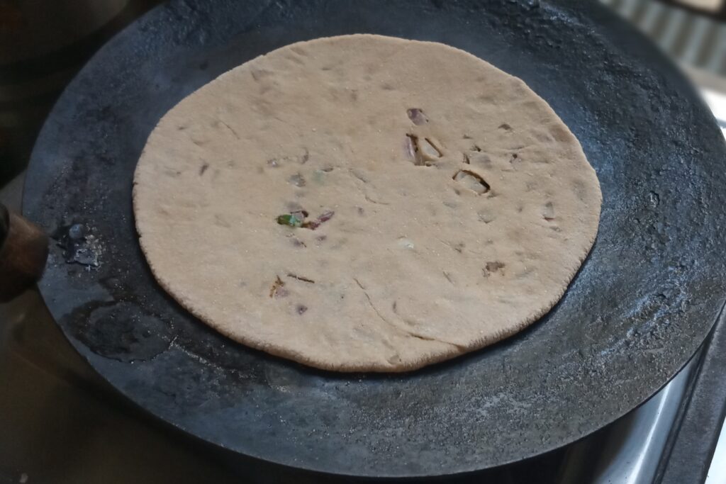 place rolled paratha on hot tawa