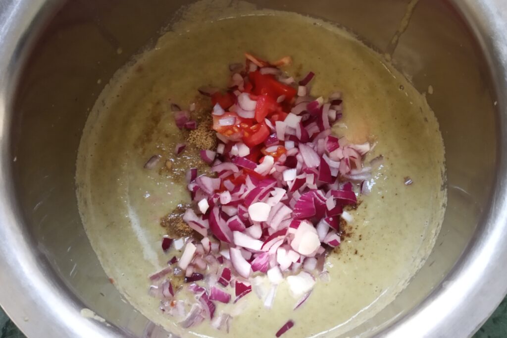 adding onion and tomato to paste