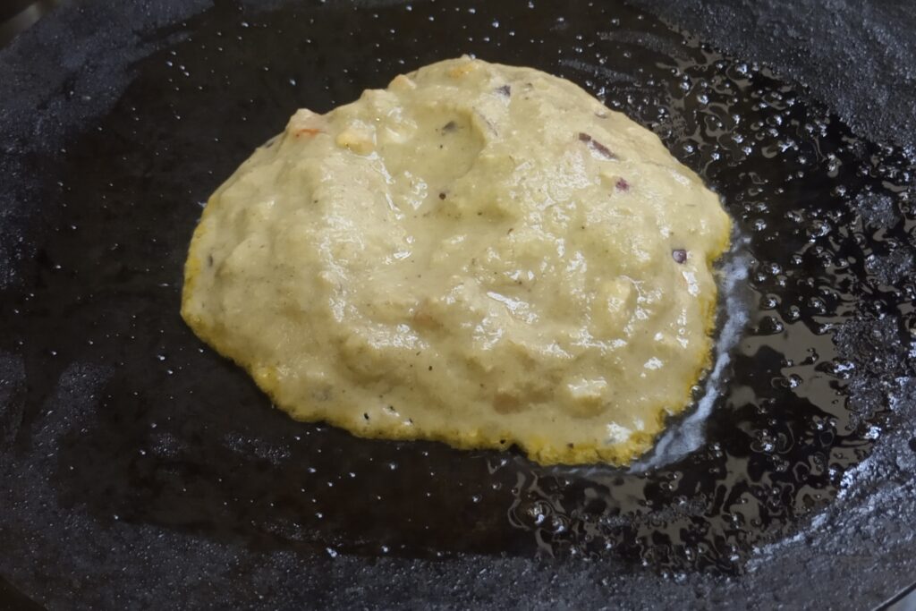 pouring batter on the tawa