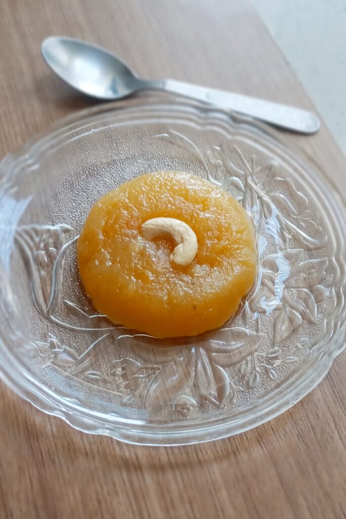 aloo halwa recipe served with a topping of cashew