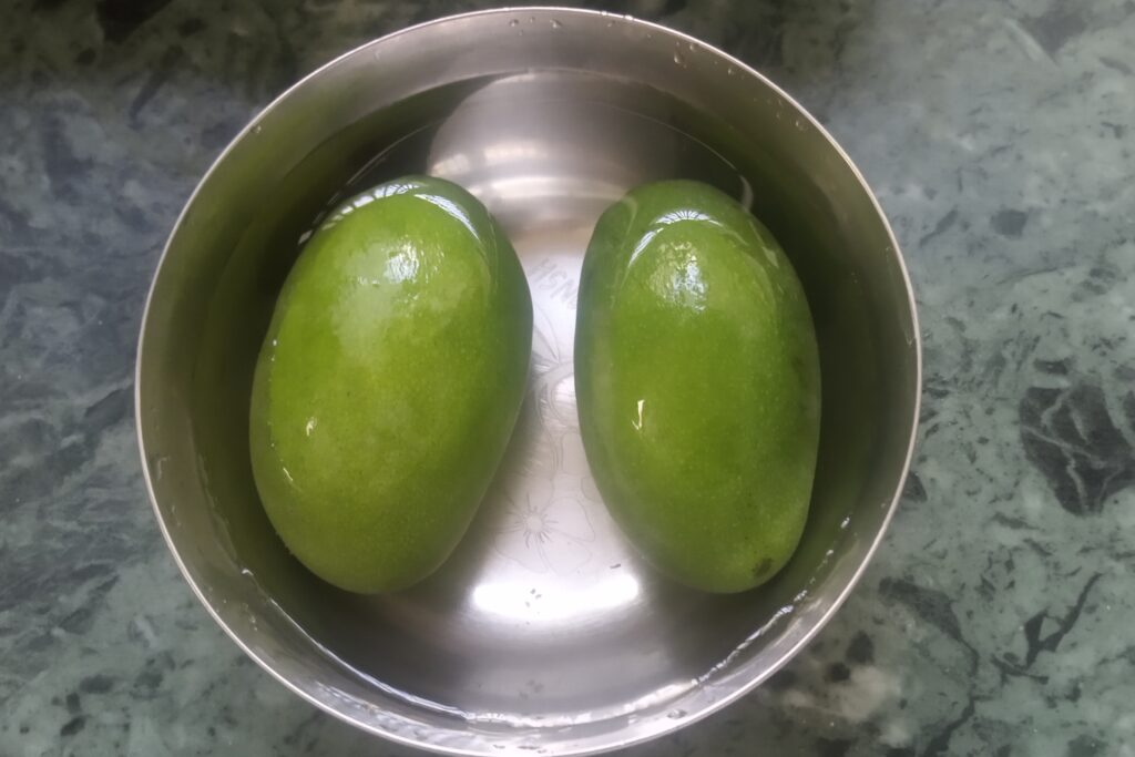 two raw mangoes in the water