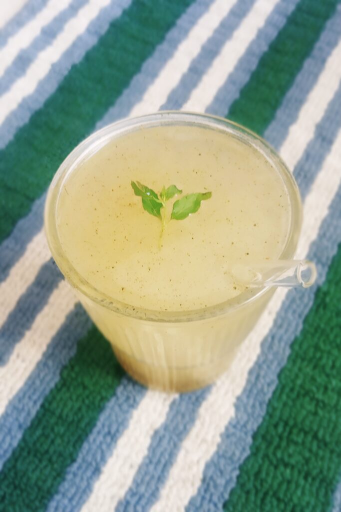 aam panna recipe served in a glass with straw