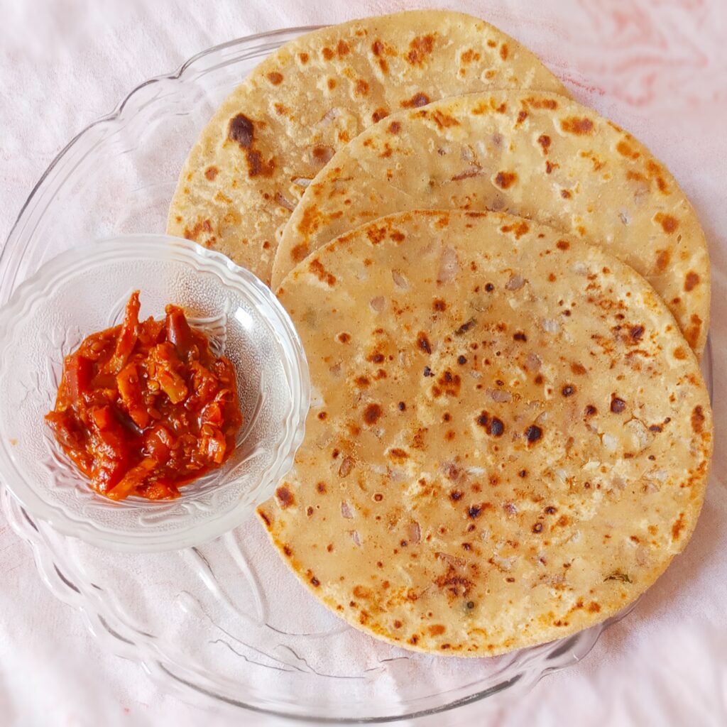 onion paratha served with mixed pickle