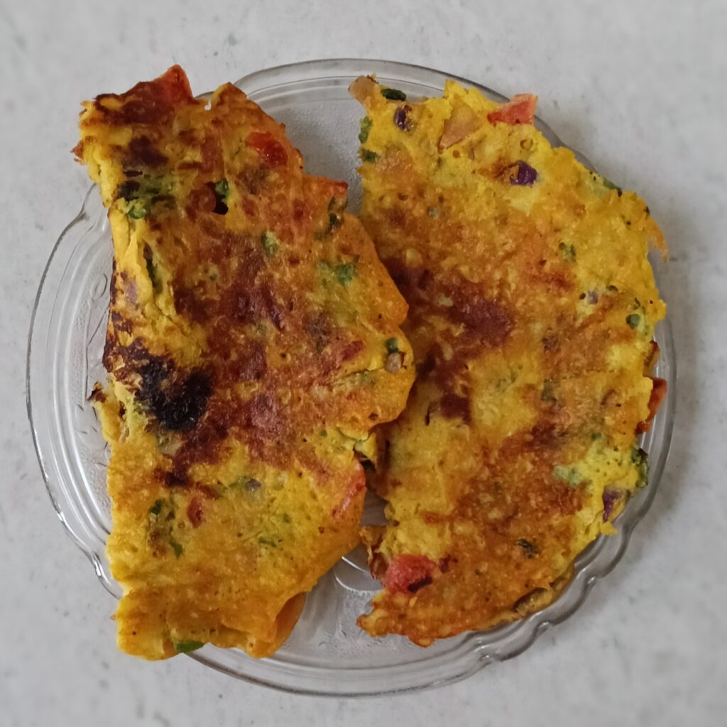 two besan chilla kept in a plate