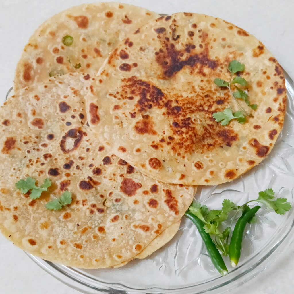 gobhi paratha garnished with herbs