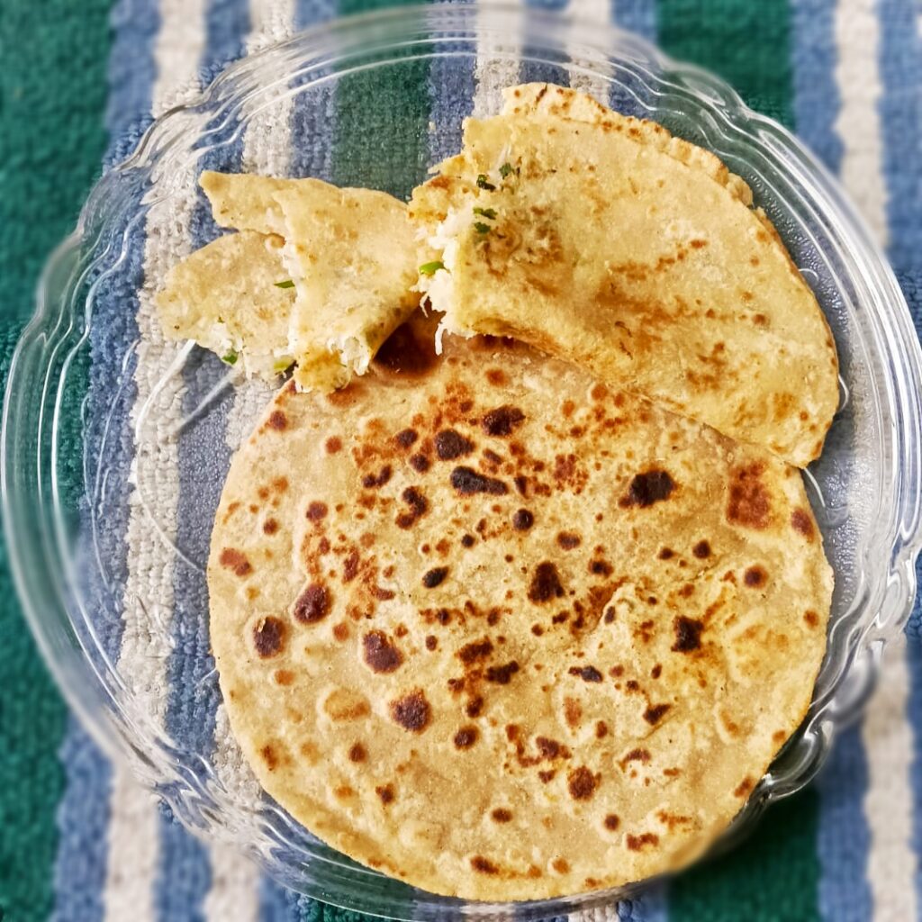 crsipy mooli paratha served in glass plate