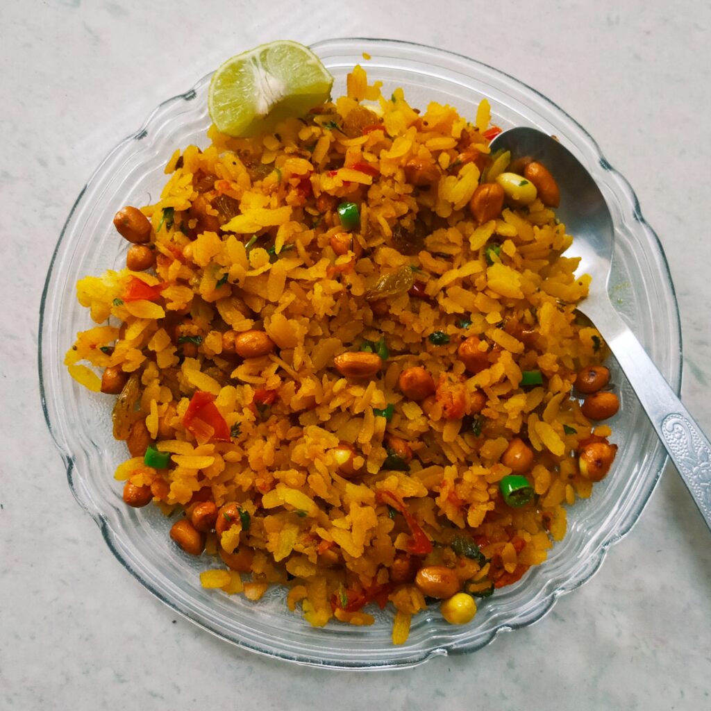 fluffy poha with a garnish of lemon