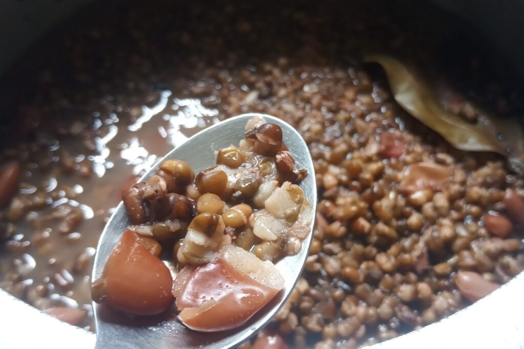 checking the rajma and dal is cooked