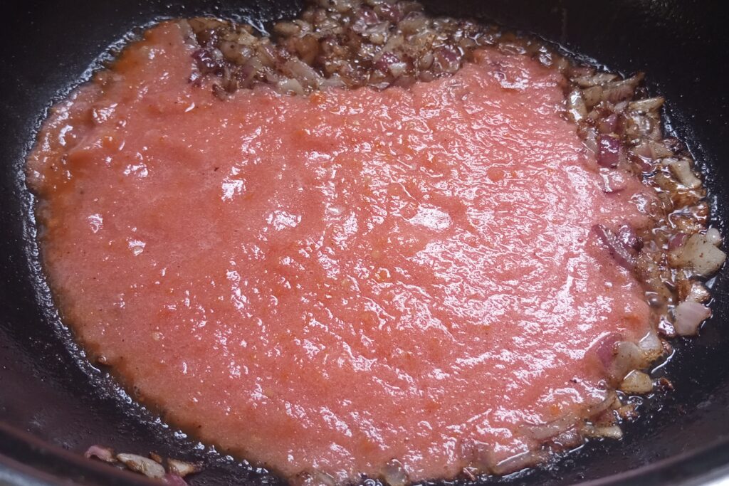adding tomato puree