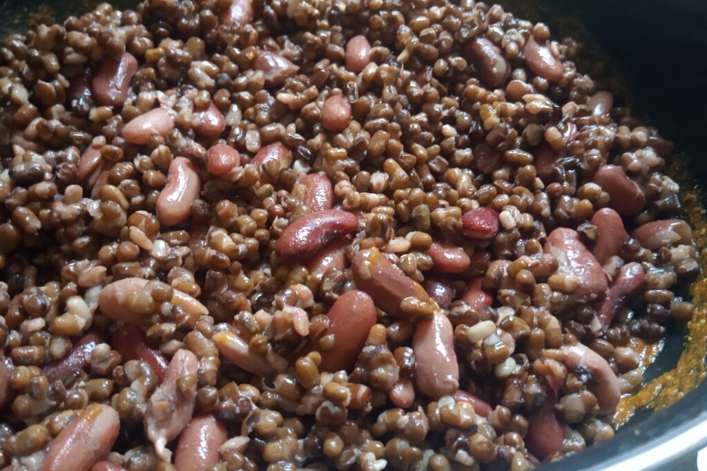 adds boiled dal and rajma in masala