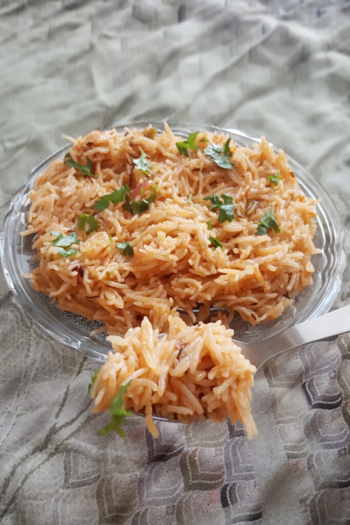 delicious onion pulao in a plate or spoon