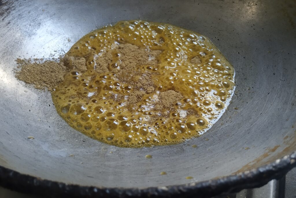 sauteing coriander powder in the oil