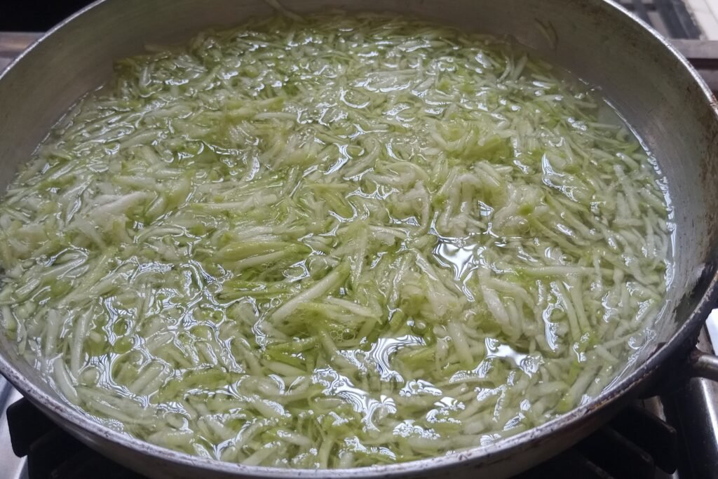 cooking bottle gourd in a pan