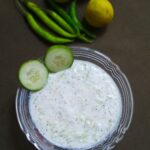 lauki raita recipe with sliced cucumber in a bowl