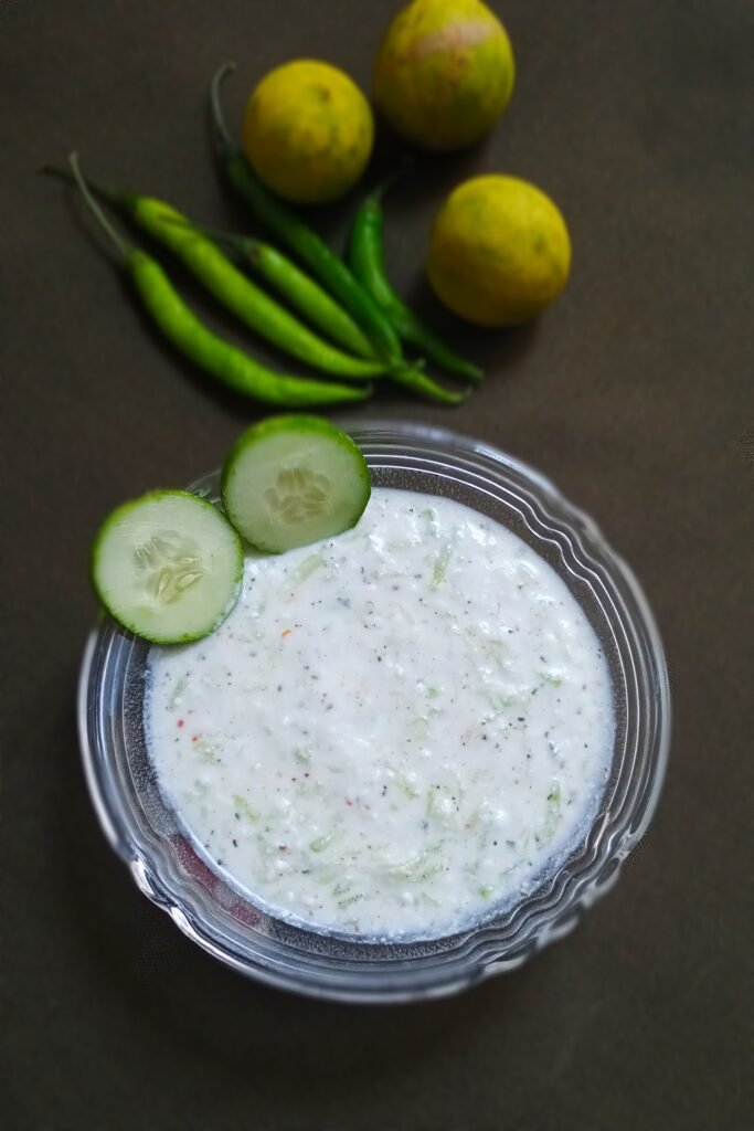 top shot of lauki raita recipe and cucumber wedges