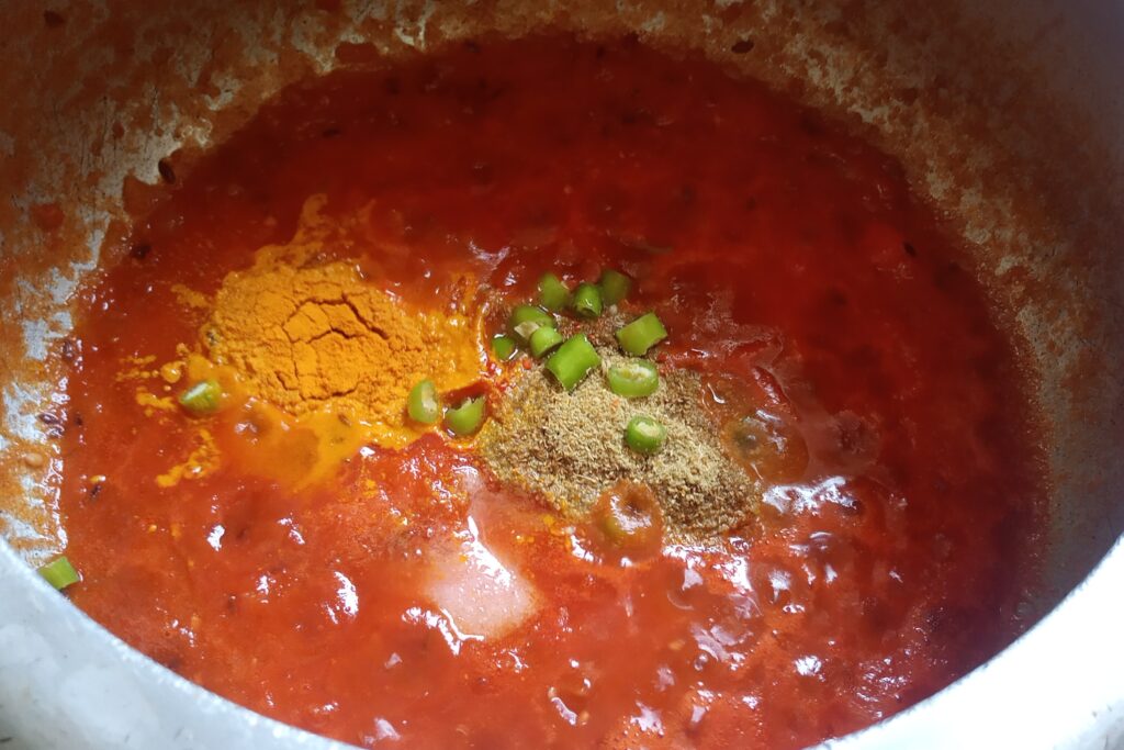 season spices into tomato puree