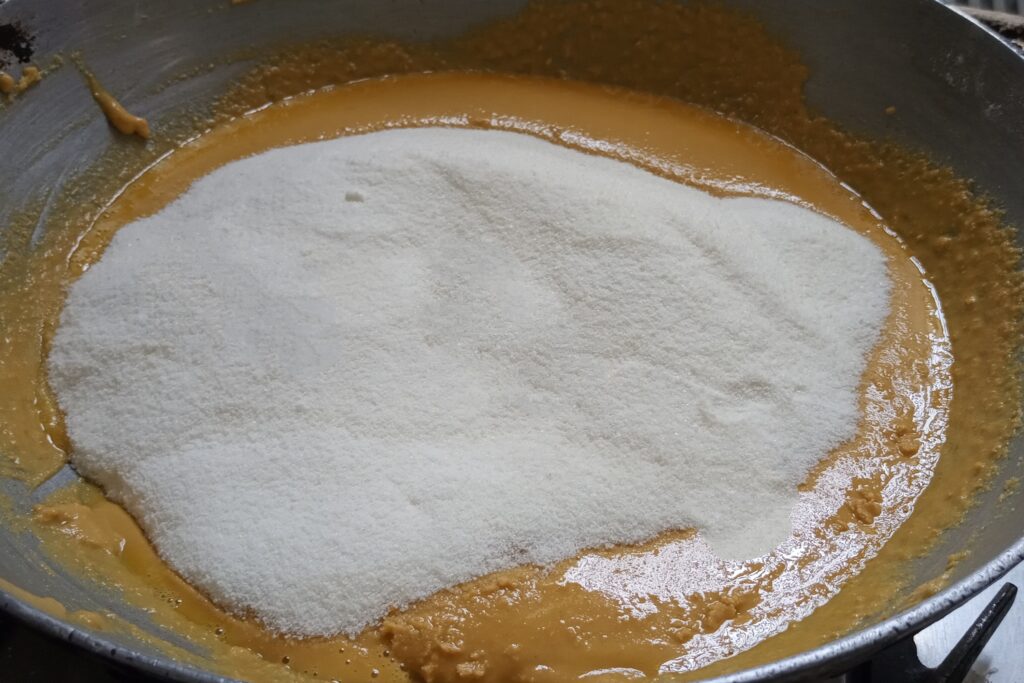 adding sugar in the roasted besan