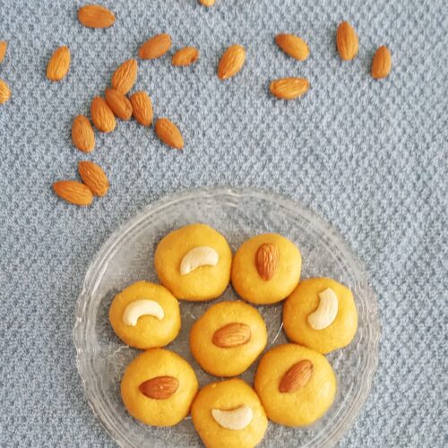 besan ladoo recipe garnished with nuts