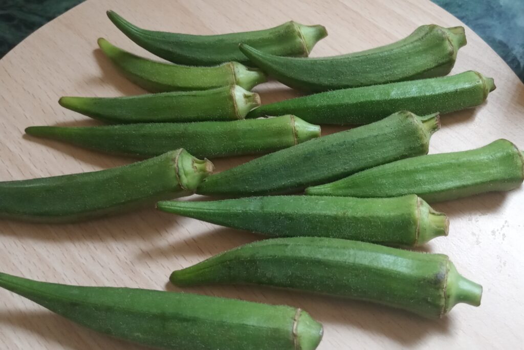 fresh small okra on the chopping board