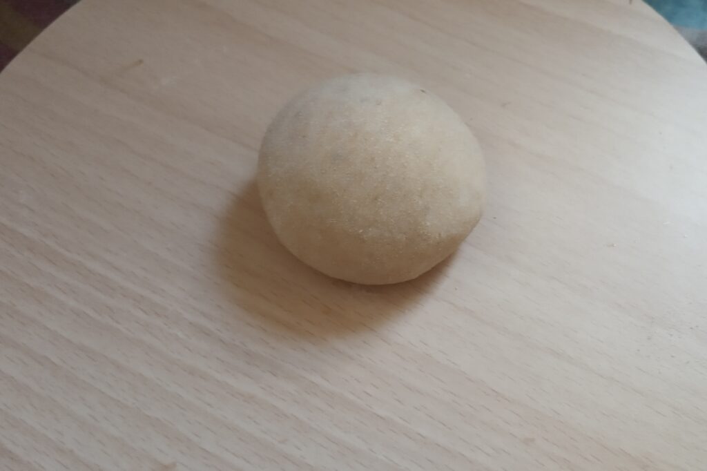wheat dough ball on the rolling board