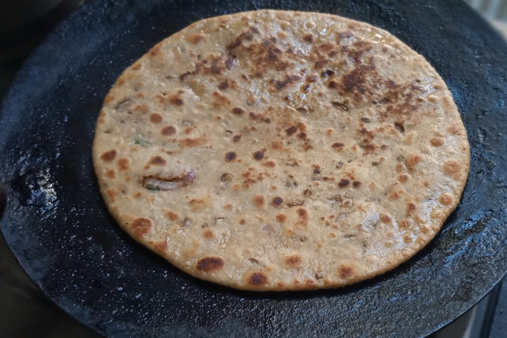 the stuffed sattu paratha with golden flakes