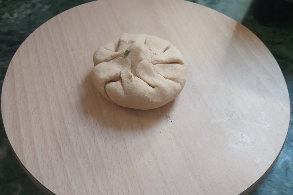 the paneer filling is sealed in wheat dough