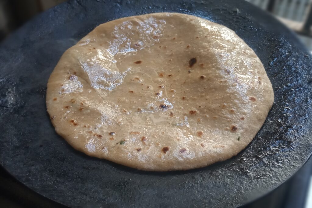 cooking paneer paratha on medium heat
