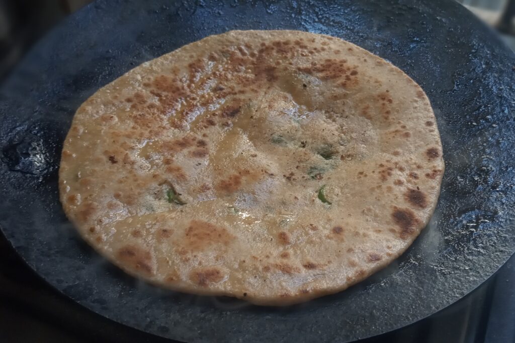 the paneer paratha is roasted completely