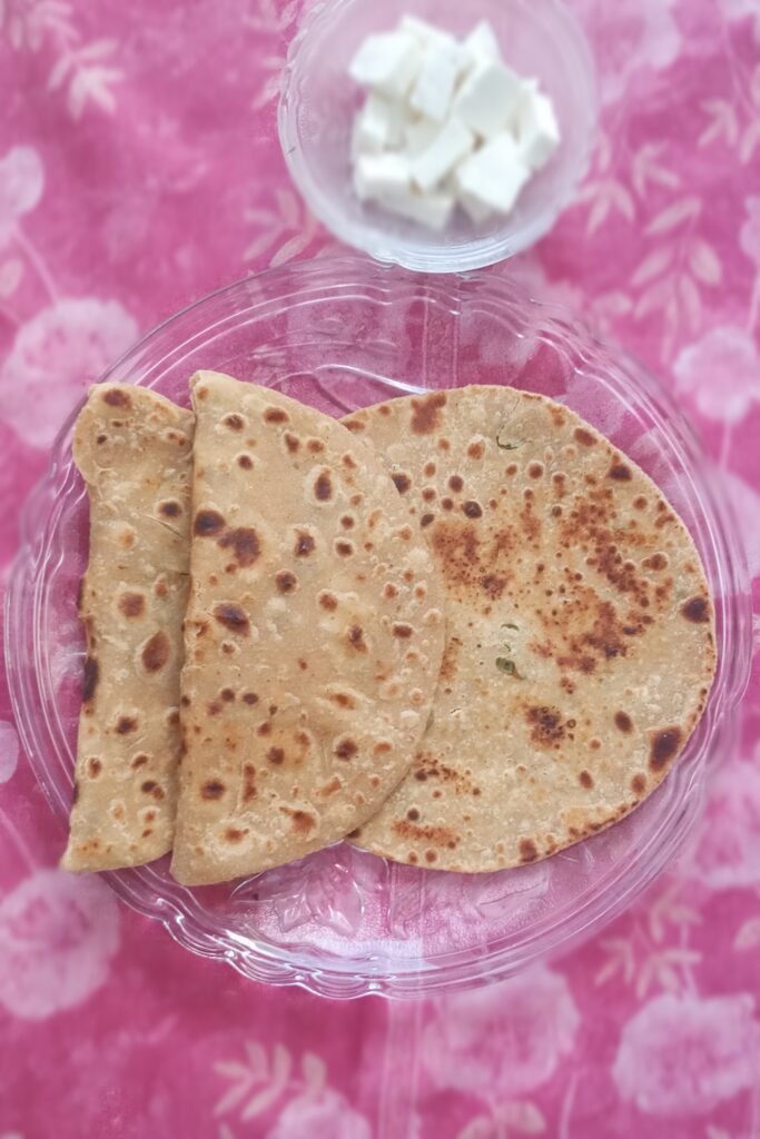 top shot of stuffed paneer paratha and paneer cubes