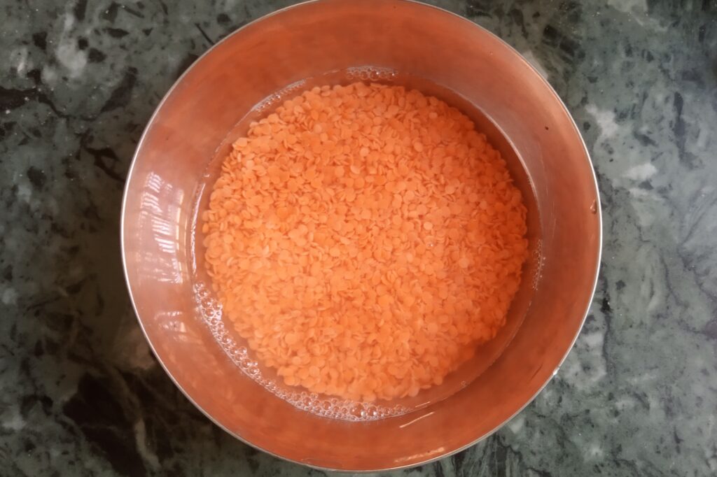 soaked red lentils in the bowl