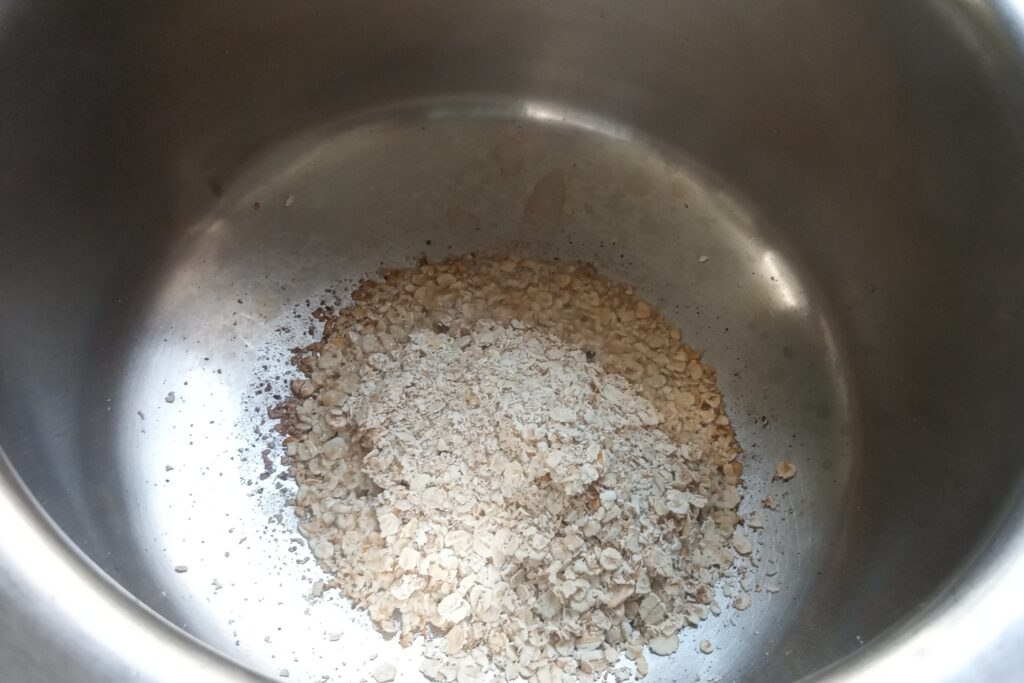 adding rolled oats to roast