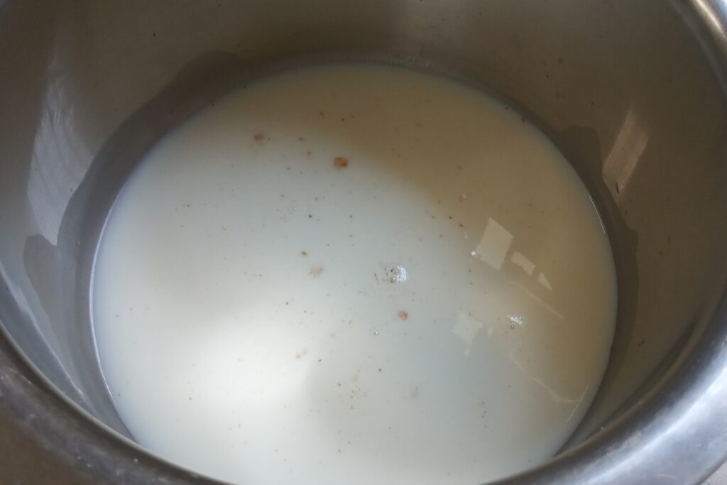 adding milk to the roasted oats