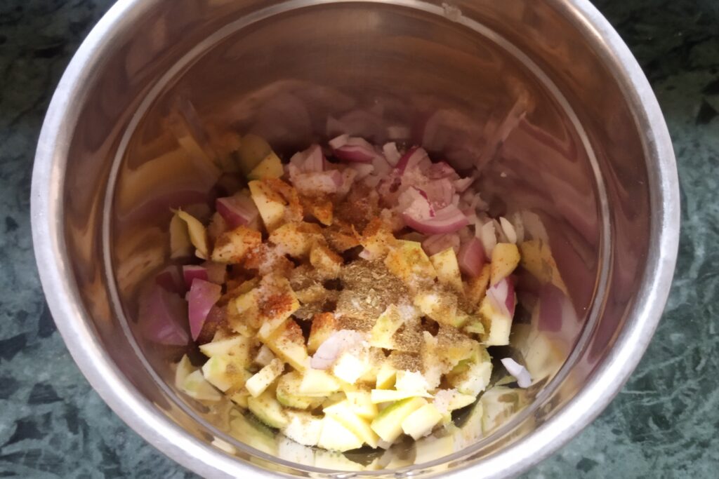 adding spices to the mangoes and onions