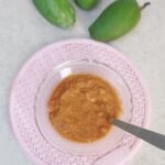 raw mango chutney on pink surface