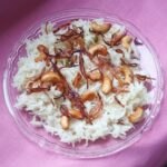 ghee rice garnished with sauteed cashews and onions