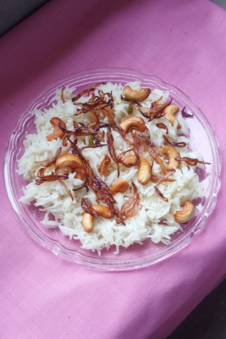 ghee rice garnished with sauteed cashews and onions