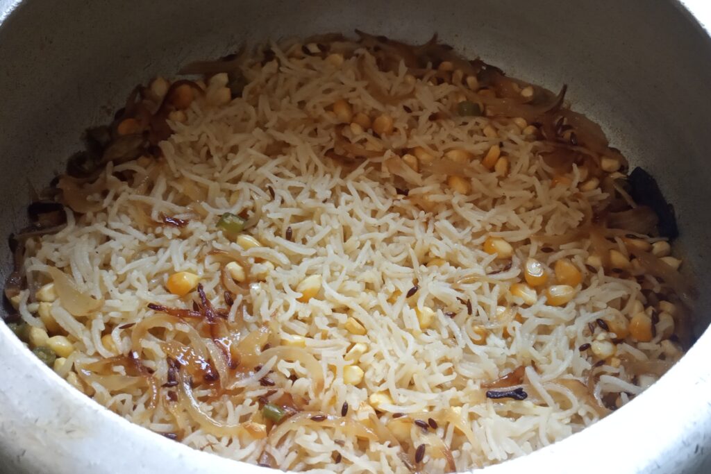 the corn rice is completely cooked