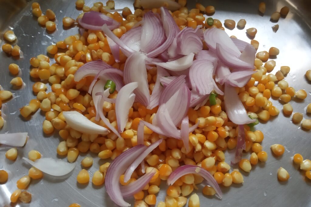 sliced onion and chilies with boiled corn