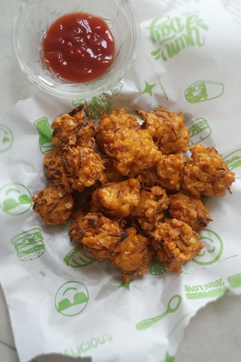 corn pakora or corn fritters served with tomato ketchup