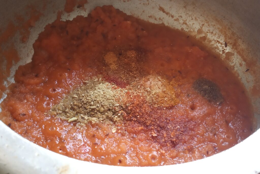 Adding spices in tomato puree