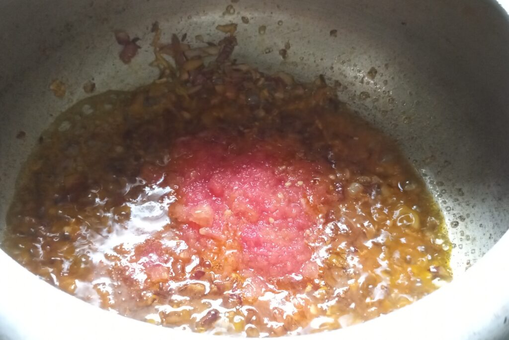 Adding tomato puree
