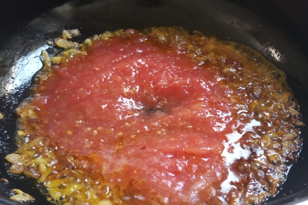 Adding tomato puree