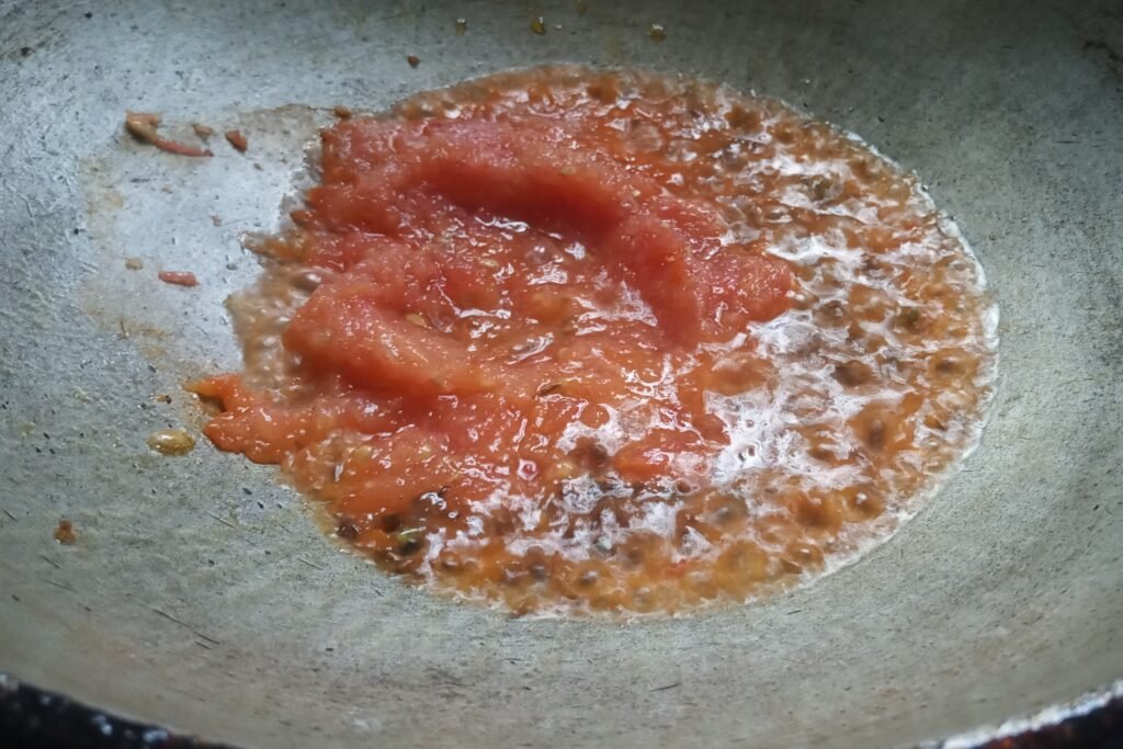Adding tomato puree