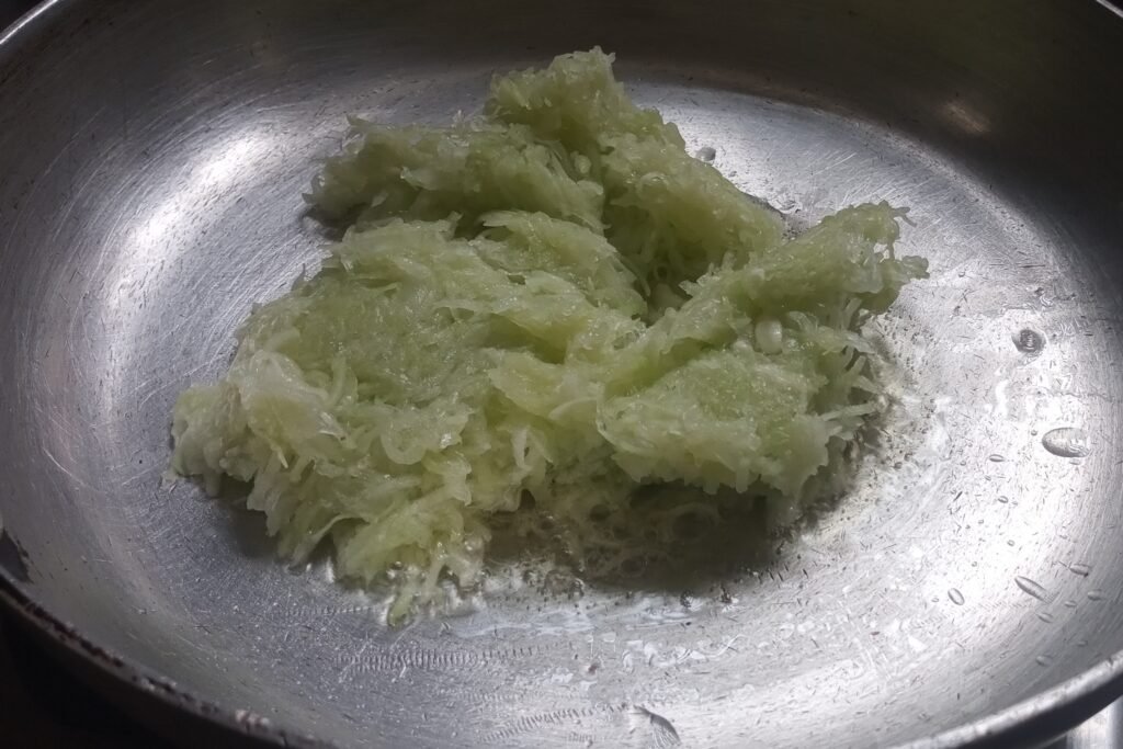Adding lauki in a pan